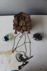 lot 571 image: antique  cuckoo clock and hand-blown glass fish figurines and paperweights