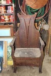 lot 573 image: lambing chair or a similar style of early high-backed hall chair with storage compartments.