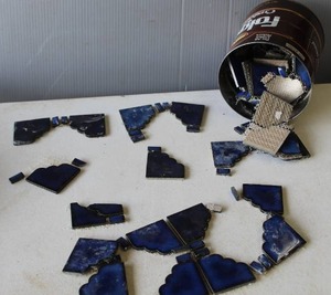 lot 635 image: Coffee can full of dark blue,tiles arranged for a project.