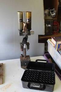 lot 649 image: vintage Texan shotshell reloading press, used for manufacturing shotgun ammunition. And MTM Case-Gard shotgun ammunition box, specifically designed for storage and transport