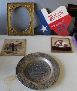 lot 709 image: wooden Texas door hanger, and decorative tile and a framed ceramic art tile and vintage pewter collectors plate celebrating the Bicentennial of the U.S. Army Corps of Engineers (1775-1975).
