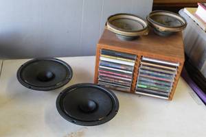 lot 711 image: 2-speaker J.W. Davis & Company model DS-805. And  2 -speaker 25 w and CDs with holder thats two sided with cds