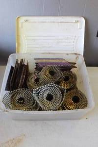 lot 804 image: Tote full of ring shank coil nails,&collated nails for a nail gun.