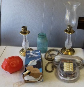 lot 828 image: Glass piggy bank, & vintage transparent telephone & vintage brass and glass hurricane candle holder and one with out the glass  and more see pictures for details