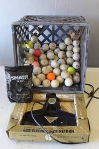 lot 836 image: electric putting return device for golf practice and a milk crate  of used golf balls and a bag of Smath tiles