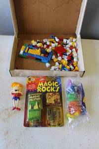 lot 840 image: assorted LEGO bricks & Magic Rocks instant crystal growing kit & 2002 Sonic Drive-In Wacky Pack bendable figure of a girl with braces & ty toy