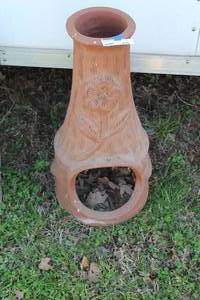 lot 876 image: decorative and functional clay chiminea, designed as an outdoor fireplace.