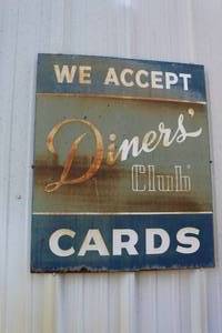 lot 893 image: vintage metal sign advertises the acceptance of Diners Club cards  3 foot tall by 30 inches wide