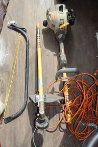 lot 144 image: Ryobi yardweed trimmer (condition unknown) with extension cord and hand saw