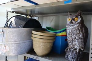 lot 10 image: Owl decoy, plastic bins, planters, and metal tubs