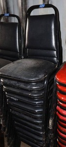 lot 194 image: Stackable black cushion chairs with metal frame - 12 total