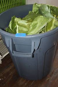 lot 54 image: Small trach bin full of green linens silky and sheer