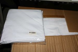 lot 50 image: New in packaging white table linens