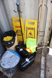 lot 258 image: Stand with plastic yellow chain, wet floor signs, paper towel holders, floor dust mop, yellow work vests, and sump pump tubing