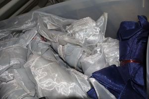 lot 82 image: Navy blue and white sheer pieces and satin table fabric decorations