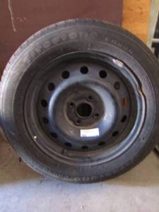 lot 28 image: FIRESTONE  18565-R15 TIRE,  RIM IS BENT