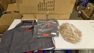 lot 719 image: Lot of 3 The Botanist Island Dry Gin Bartender Aprons & Bag of Wooden The Botanist Pens