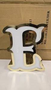 lot 732 image: Large Letter E Gold & White Channel Letter.  15 Tall.  Can be wired for light.  Would make a great dcor piece