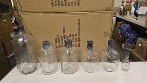 lot 767 image: Lot of 6 Glass Drip Wax BottlesCandlestick Holders.  The Largest is 18 Tall