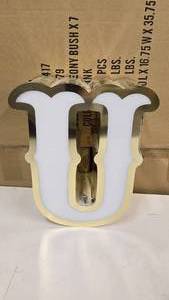 lot 789 image: Large Letter U Gold & White Channel Letter.  Can be wired for light.  Would make a great dcor piece