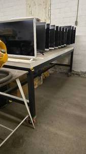 lot 1052 image: Heavy Duty Black w White Top Shop Table w Heavy Duty Casters.  Measures 4 x 8.  Contents Not Included.&nbsp THIS ITEM CAN ONLY BE PICKED UP ON DAY 3 OF REMOVAL