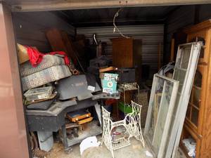 lot 7 image: STORAGE UNIT (M) --GRILL, SINGER SEWING BASE, WINDOWS, CABINETS, SHELVES, WASHER,DRYER, FREEZER, LADDER, FISHING POLE, PIGGY BANK, SIDE RAILS, YARD TOOLS PLUS