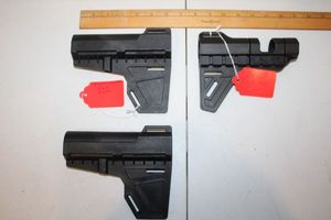 lot 84 image: Three pistol stabilizers as shown