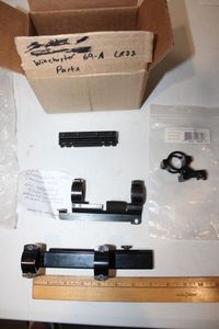 lot 251 image: Colt mount, Numrich M1 carbine 1 scope mount, Magpul cheek riser (box marked Winchester 69A LR22 parts)