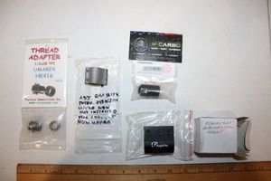 lot 277 image: Flashlight mount, adj. gas block, thread adapter, and Hi-Point ext. charging handle