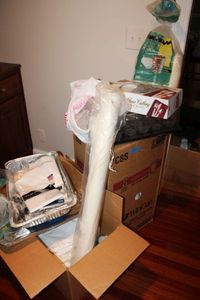 lot 47 image: Plastic kitchen cutlery, kitchen items, tablecloths, aisle runner, and styrofoam cups