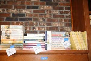 lot 68 image: Books Little House on the Prairie books, Marian Wells, Lori Wick, and Michael Phillips books.