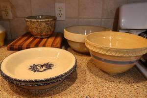 lot 126 image: Stoneware bowls and pie plates with footed cutting board
