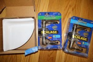 lot 158 image: Schlage door handle levers and porcelain corner shower shelf