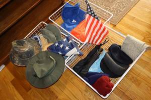lot 189 image: Hats, poncho, umbrellas, and flag
