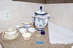 lot 206 image: Vintage teapot and cups, Blue and white Biscotti jar and lacy round tablecloth