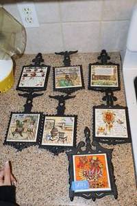 lot 119 image: Iron trivets with decorative tiles