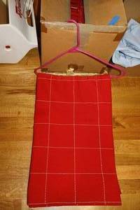 lot 153 image: Christmas mugs, red cloth napkins and tablecloth , silver plated creamer and sugar bowl plus bread basket, Christmas stockings and snowman decor
