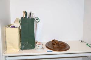 lot 300 image: Gift bags, ribbons, praying hands wall art