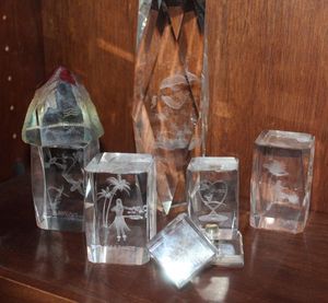 lot 56 image: Deceptive 3D Laser fetched Crystal Glass Paper weights Featuring a various scenes, Such as Dolphins, Palm Trees, and Hearts.