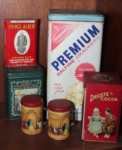 lot 59 image: Collection of Vintage Advertising Tins, featuring a Nabisco Premium Saltine Crackers tin (1969) and Drostes Cocoa Tin made in Harlem, Holland. Rosies Strawberry Farm, (3x3x4) and Prince Albert Tobacco, (1960-1980) Vintage salt and Pepper Shakers