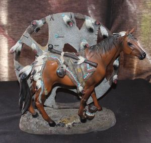 lot 68 image: Vintage Collectible Figure Depicts a Native American War Horse Adorned With Traditional Feathers, Beads, and Saddle Against a Stylized Dream catcher Backdrop