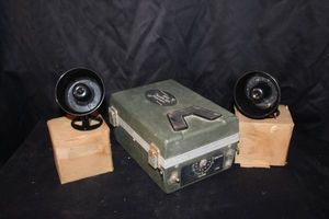 lot 103 image: Vintage Johnnys Stewart Super Deluxe game caller, features a rugged green case with horn speakers and is designed to attract wild game