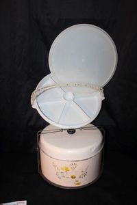 lot 146 image: Vintage Metal CakePie Carrier 1940s-1950s and a Vintage tupperware party Susan Serving tray from the 1960s-1970s which included a sectional dish, lid and detachable strap
