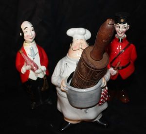 lot 179 image: Two Vintage Canadian Mountie ceramic whiskey decanters from the mid-20th century. Vintage wooden rolling pin featuring hand-carved designs. Ceramic Chef decor piece