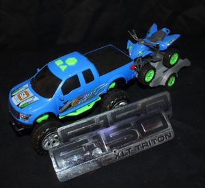 lot 176 image: Raxx Wheel Light &amp Sound Sport Trailer playset, which includes a pickup truck, a detachable trailer, and an off-road vehicle. Also 2 F150 truck Bafges