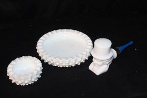 lot 162 image: Two nesting hobnail milk glass ashtrays and a milk glass avon decanter pipe