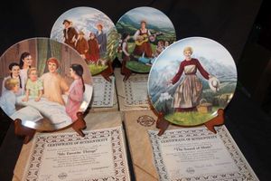 lot 185 image: Four The Sound of Music fine China collector plates manufactured by Edwin M. Knowles, featuring scenes from the musical and including their certificate of authenticity