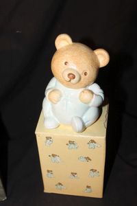 lot 215 image: Vintage 1986 Avon Baby Teddy Bear piggy bank featuring bear in blue pajamas with orginal box