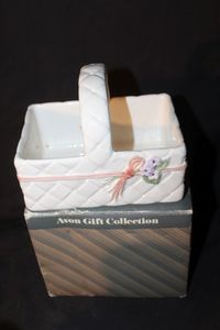 lot 216 image: Vintage Avon Gift Collection White Ceramic basket with woven pattern, pink ribbon, and violet floral accent