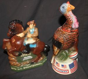 lot 218 image: Two Vintage Bicentennial ceramic decanters Old Mr. Boston featuring Paul Revere on horseback, and Austin Nichols ceramic Wild Turkey Spirit of 76 limited edition decanter.